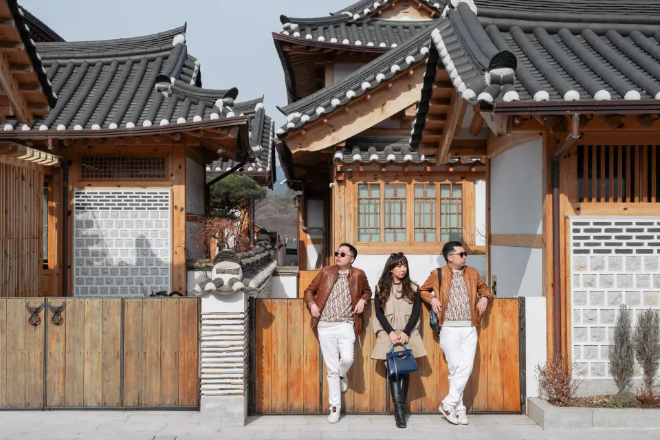 A group standing in front of hanok houses